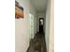 Hallway with wood-look tile floors and access to bedrooms and bathroom at 2746 Lanai Ln, Greenwood, IN 46143
