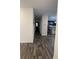 Hallway with wood-look tile floors leading to bedrooms and the kitchen at 2746 Lanai Ln, Greenwood, IN 46143