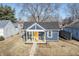 Cute blue bungalow with a yellow door and small front yard at 305 Hamilton St, Fortville, IN 46040