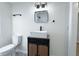 Clean bathroom with a white sink, dark wood vanity, and black accents at 305 Hamilton St, Fortville, IN 46040