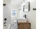 Updated bathroom features a stylish vanity, modern fixtures, and patterned tile floor at 305 Hamilton St, Fortville, IN 46040