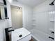 Modern bathroom with a white vessel sink, black fixtures, and a shower/tub combo at 305 Hamilton St, Fortville, IN 46040