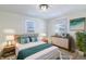 Bright bedroom with a comfortable bed, and light wood furniture with decor at 305 Hamilton St, Fortville, IN 46040