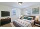 Cozy bedroom with a comfortable bed, wood furniture, and lots of natural light at 305 Hamilton St, Fortville, IN 46040
