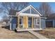 Charming bungalow with a yellow door and covered porch at 305 Hamilton St, Fortville, IN 46040