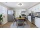 Eat-in kitchen features stainless steel appliances, white cabinets, and a charming round dining table at 305 Hamilton St, Fortville, IN 46040