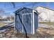 Blue storage shed with white trim in backyard at 305 Hamilton St, Fortville, IN 46040