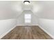 Finished attic with a window that provides natural light and hardwood flooring at 3102 N Arsenal Ave, Indianapolis, IN 46218