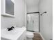 Modern bathroom with glass-enclosed shower, sleek black fixtures, and neutral color scheme at 3102 N Arsenal Ave, Indianapolis, IN 46218