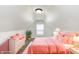 Charming bedroom features a pink bed set, plush rug, and natural light from the window at 3102 N Arsenal Ave, Indianapolis, IN 46218