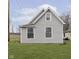 Charming home with light gray vinyl siding, bright white trim, and a well-maintained lawn at 3102 N Arsenal Ave, Indianapolis, IN 46218