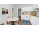 Bright kitchen featuring white cabinets, butcher block countertops, and a cozy eat-in area at 3102 N Arsenal Ave, Indianapolis, IN 46218