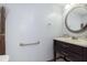 Cozy half bathroom with a dark wood vanity and decorative mirror at 5183 Fairway Dr, Avon, IN 46123