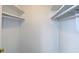 Empty walk-in closet with white walls, shelving and hanging rods at 5183 Fairway Dr, Avon, IN 46123
