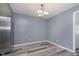 Bright dining area with hardwood floors, neutral wall paint, and contemporary lighting fixture at 5183 Fairway Dr, Avon, IN 46123