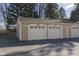 View of detached garage with multiple parking spaces and individual bay doors at 5183 Fairway Dr, Avon, IN 46123