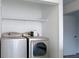 Laundry area with a front-load washer and dryer under a shelf at 5183 Fairway Dr, Avon, IN 46123