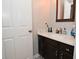 Bathroom with dark brown vanity, quartz countertop, and sink at 6639 N College Ave, Indianapolis, IN 46220