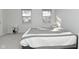 Main bedroom with two windows, gray carpet, and a queen bed at 6639 N College Ave, Indianapolis, IN 46220
