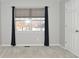 Bright bedroom with neutral walls, carpeting, and window with curtains at 6639 N College Ave, Indianapolis, IN 46220