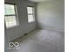 Bedroom featuring neutral carpeting and two windows bringing in natural light at 6639 N College Ave, Indianapolis, IN 46220