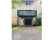 Two-story townhouse with attached garage, porch, and landscaped yard at 6639 N College Ave, Indianapolis, IN 46220