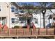 Tan two-story townhome with a wooden deck and small front yard at 6639 N College Ave, Indianapolis, IN 46220