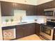 Kitchen featuring stainless steel appliances, sleek counter tops and dark cabinets at 6639 N College Ave, Indianapolis, IN 46220
