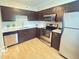 Kitchen featuring stainless steel appliances, sleek counter tops and dark cabinets at 6639 N College Ave, Indianapolis, IN 46220