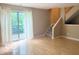 Bright living room features hardwood floors, large windows, and access to a private deck at 6639 N College Ave, Indianapolis, IN 46220