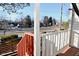 Small front porch with wooden railing and view of residential street at 6639 N College Ave, Indianapolis, IN 46220