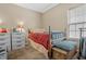 Bedroom with wooden bed frame, dresser, and window at 7842 Cork Bend Ln, Indianapolis, IN 46239