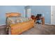 Light blue bedroom with wooden bed frame and work desk at 7842 Cork Bend Ln, Indianapolis, IN 46239
