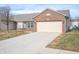 Brick ranch home with attached garage and landscaping at 7842 Cork Bend Ln, Indianapolis, IN 46239