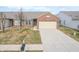 Brick ranch home with attached garage and driveway, front yard view at 7842 Cork Bend Ln, Indianapolis, IN 46239
