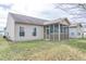 Tan house with screened porch and small backyard at 7842 Cork Bend Ln, Indianapolis, IN 46239