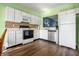 Bright kitchen with white cabinets, stainless steel appliances, and wood-look floors at 7842 Cork Bend Ln, Indianapolis, IN 46239
