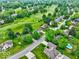 An aerial view of the home surrounded by lush greenery and a golf course at 956 Dorchester Dr, Noblesville, IN 46062