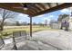 Relaxing backyard patio with pergola, seating area, and view of the golf course at 956 Dorchester Dr, Noblesville, IN 46062