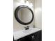 Modern bathroom with a round mirror and white countertop at 956 Dorchester Dr, Noblesville, IN 46062