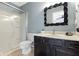 Bathroom with dark vanity and unique mirror at 956 Dorchester Dr, Noblesville, IN 46062