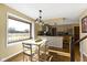 Kitchen and dining area with a large window, hardwood floors, and a table for four at 956 Dorchester Dr, Noblesville, IN 46062