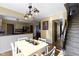 Open concept dining room with kitchen views, light wood table and chairs, and a stylish light fixture at 956 Dorchester Dr, Noblesville, IN 46062