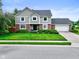 Charming two-story home featuring a manicured lawn, brick accents and an attached two car garage at 956 Dorchester Dr, Noblesville, IN 46062