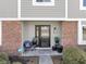 Inviting front entry with brick and siding, black door, and potted plants at 956 Dorchester Dr, Noblesville, IN 46062