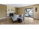Gathering room with fireplace, hardwood floors, and sliding glass doors leading to the patio at 956 Dorchester Dr, Noblesville, IN 46062