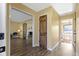 Long hallway with hardwood floors and doors to other rooms at 956 Dorchester Dr, Noblesville, IN 46062