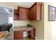 Dark wood kitchen cabinets and granite countertop with built-in desk at 956 Dorchester Dr, Noblesville, IN 46062