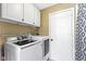 Convenient laundry room with washer, dryer, and overhead cabinets at 956 Dorchester Dr, Noblesville, IN 46062