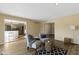 Open living room with hardwood floors, two armchairs, and a view into the kitchen at 956 Dorchester Dr, Noblesville, IN 46062